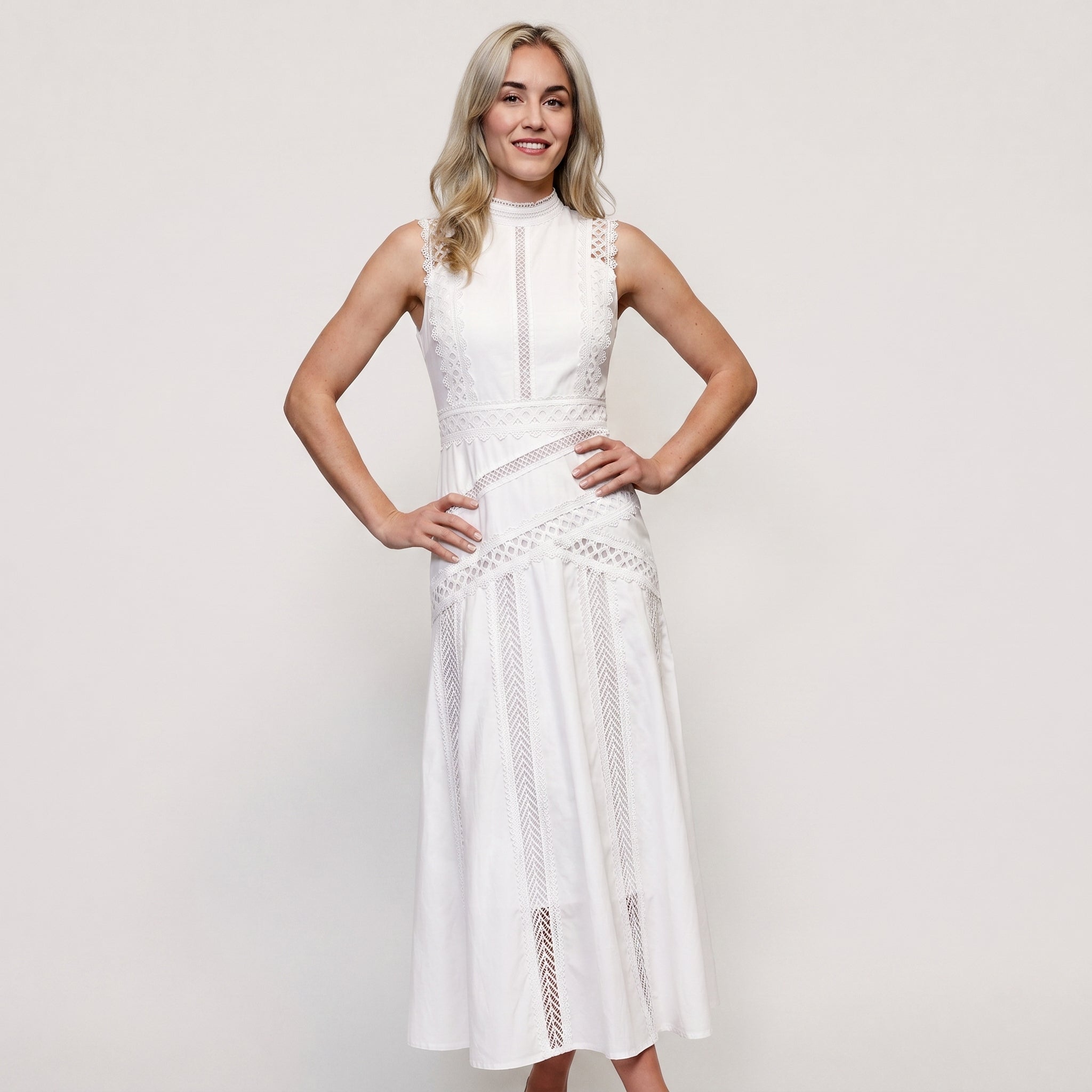 White sleeveless wedding guest midi dress with geometric cutwork lace patterns