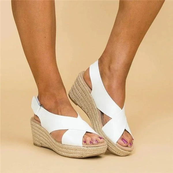 Close-up of white open-toe espadrille wedge sandals with soft leather cross straps