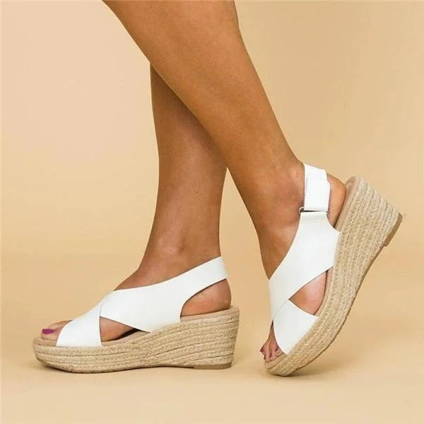 White cross strap espadrille wedge sandals with ankle buckle and woven rope platform