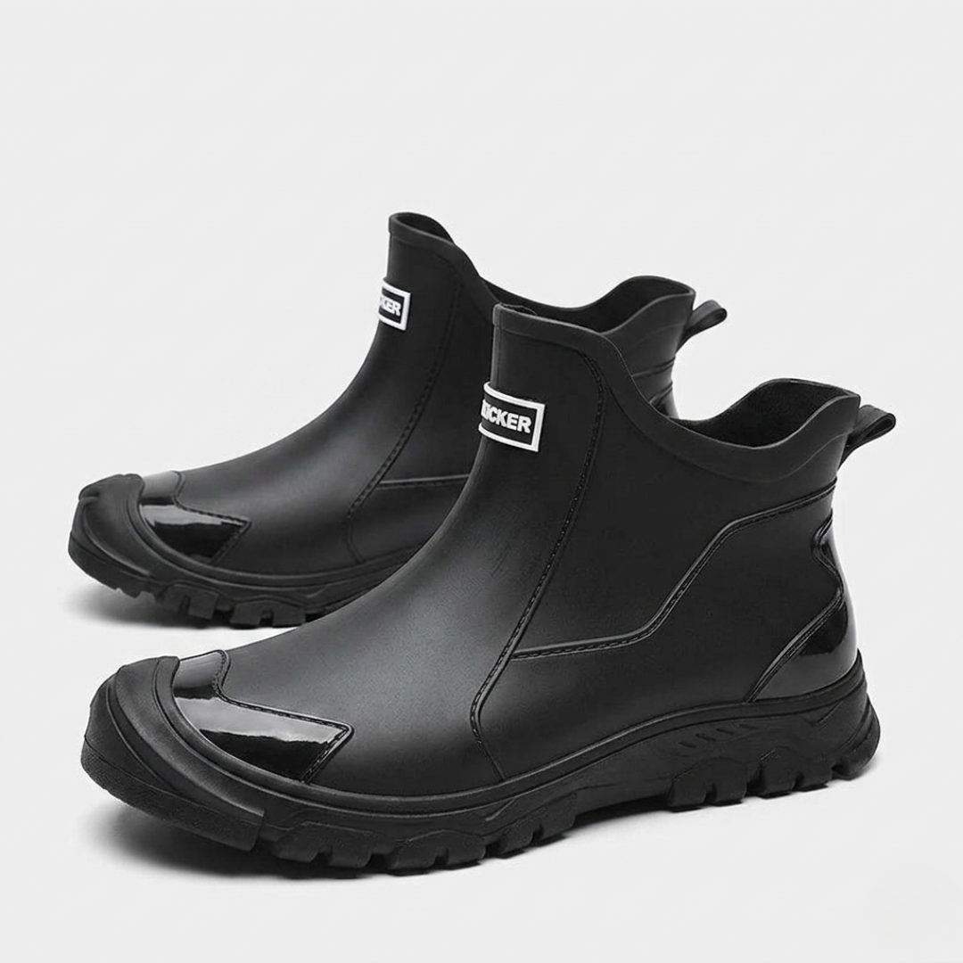 Black matte slip-on boots featuring glossy toe cap and thick tread sole