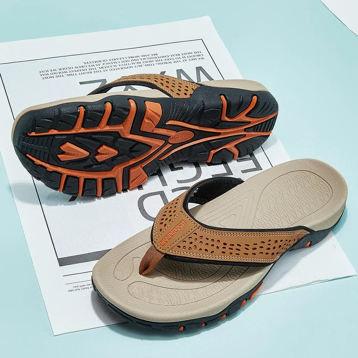 Beige and black MOBIEAR men's flip flops showing embossed footbed and orange tread