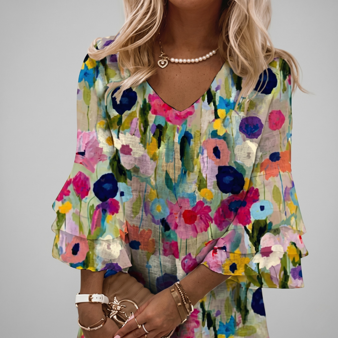 Front view of loose fit floral shift dress with layered ruffle sleeves