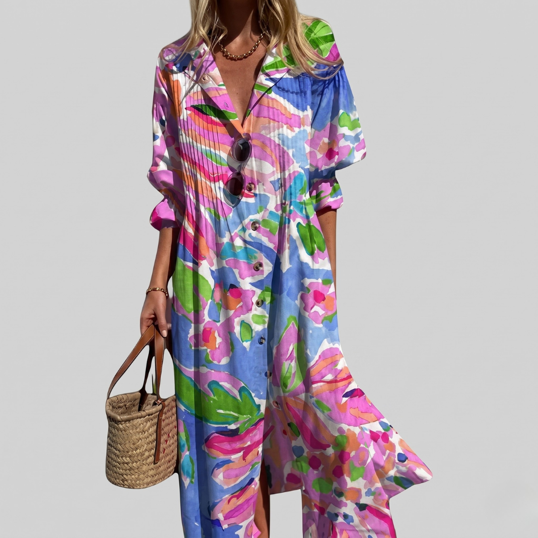 White maxi dress with colorful abstract floral print in pink and purple, pintuck pleated button-front shirt dress