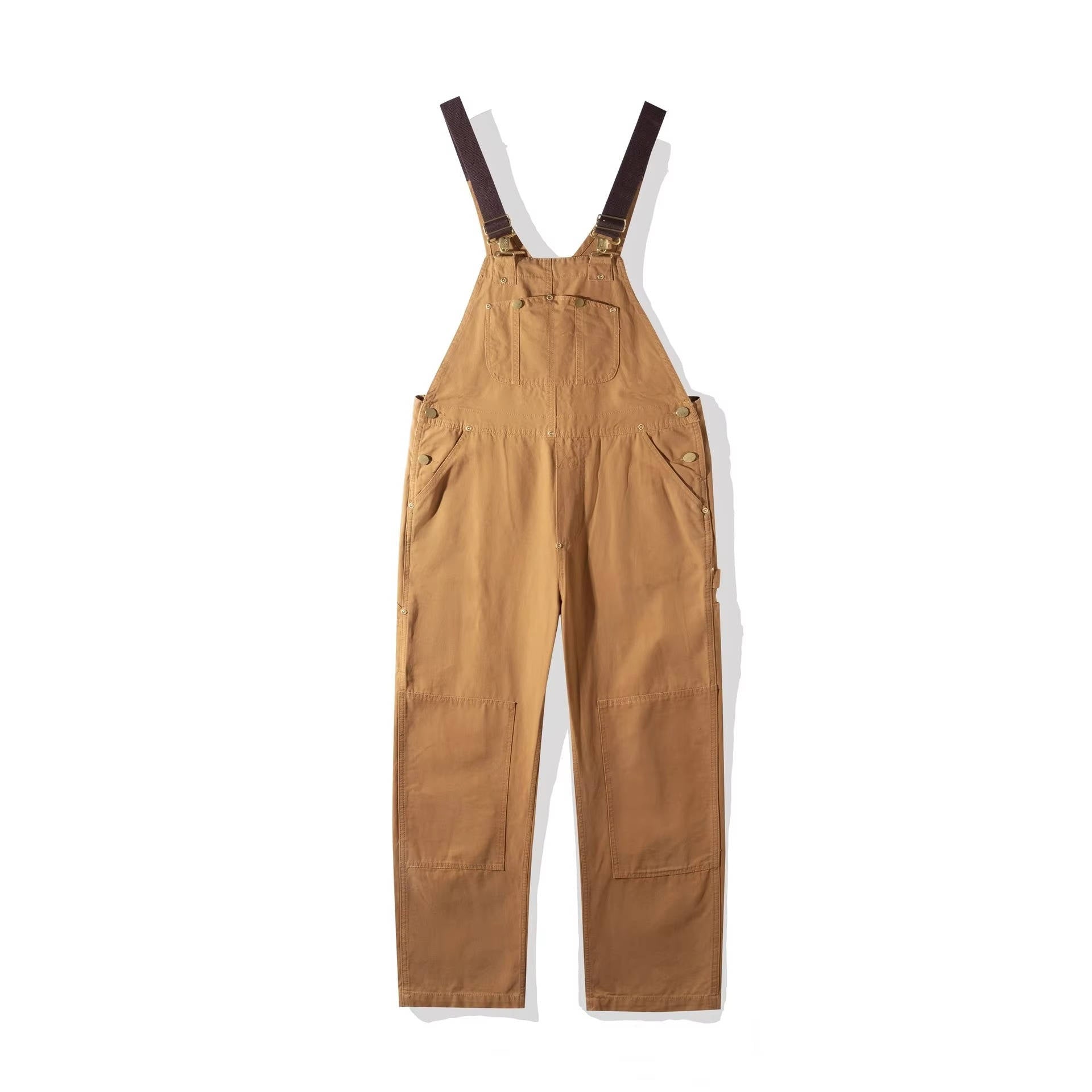Tan cotton canvas bib overalls flat lay with wide straps and relaxed fit