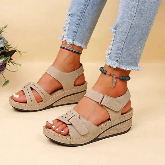 Beige women's casual wedge sandals with two buckle-fastened straps and open toe