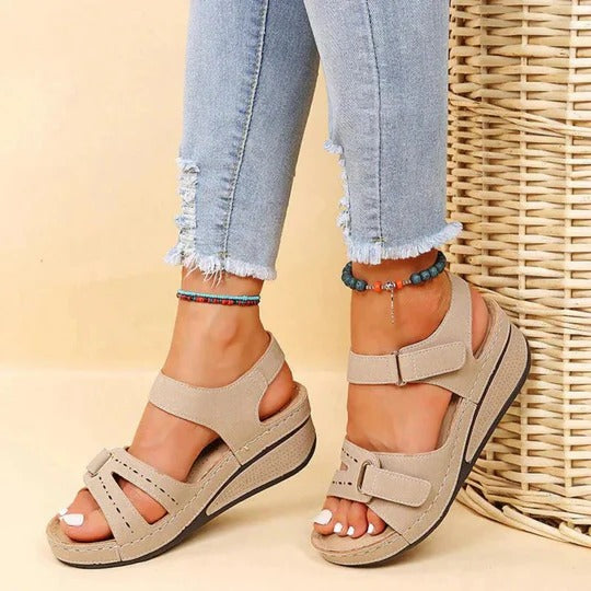 Beige adjustable strap wedge sandals with wide fit and textured platform sole