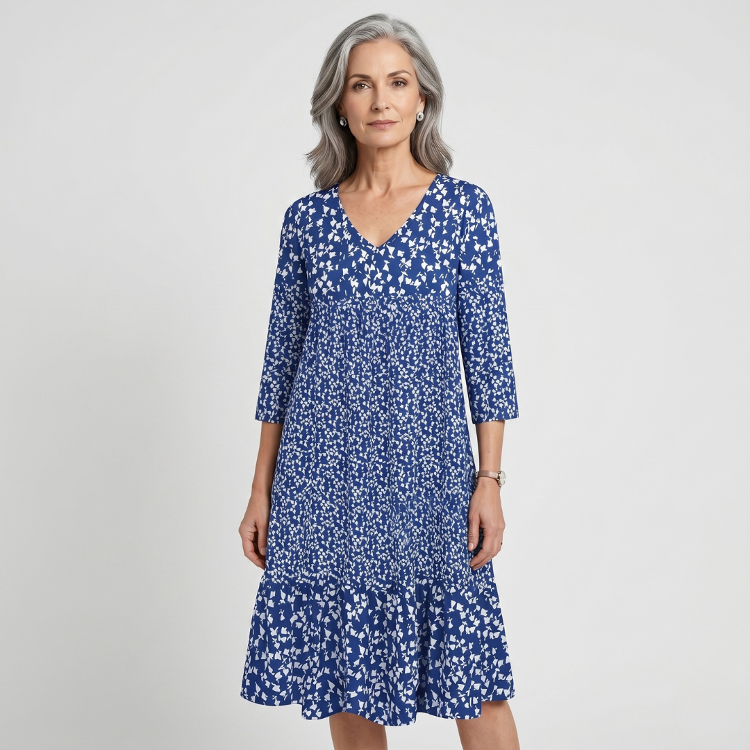 Blue floral midi dress with V-neck and ruffled hem on model