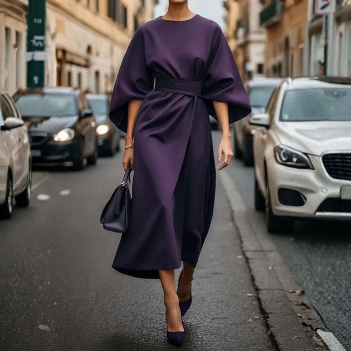Deep purple batwing sleeve midi dress with cinched waist and draped front panel
