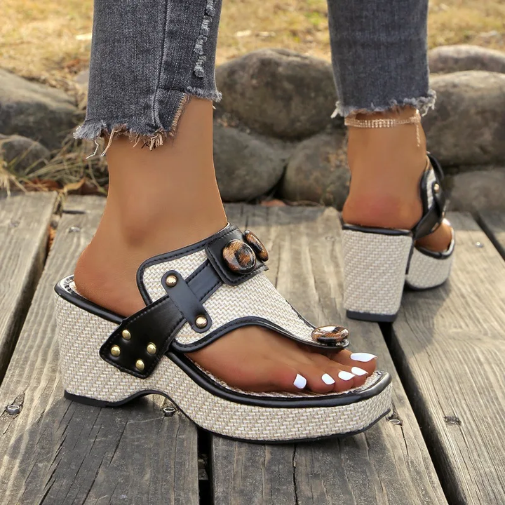 Rear view of studded platform slides with textured block heel