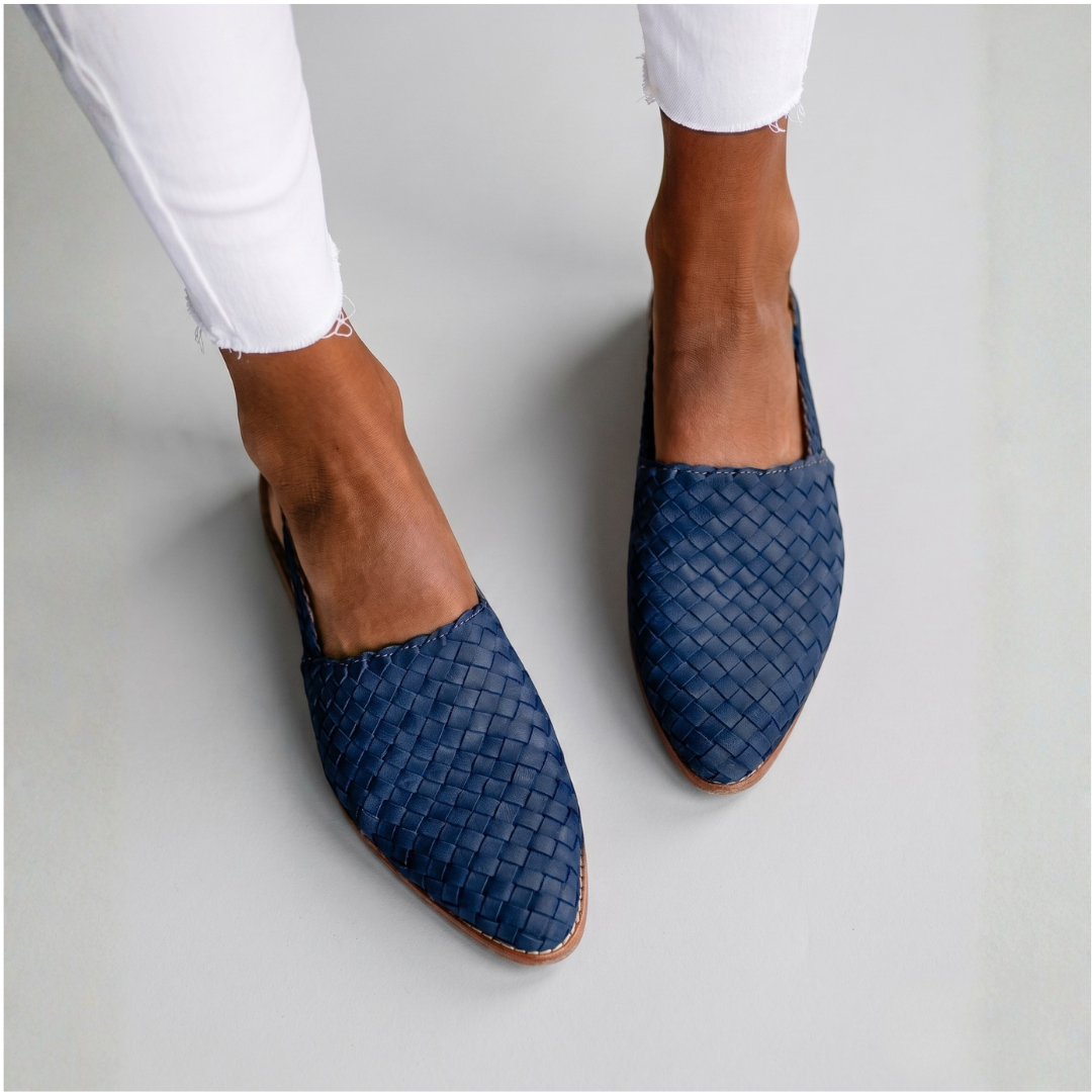 Navy blue woven orthopedic mules with open back and low-profile supportive silhouette