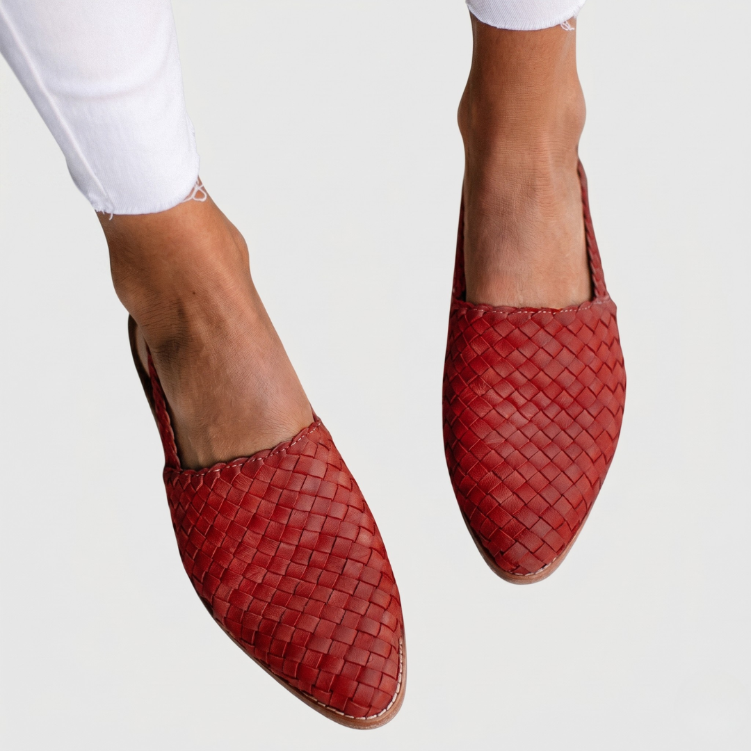 Red woven orthopedic sandals with tight basket-weave texture and brown rubber sole