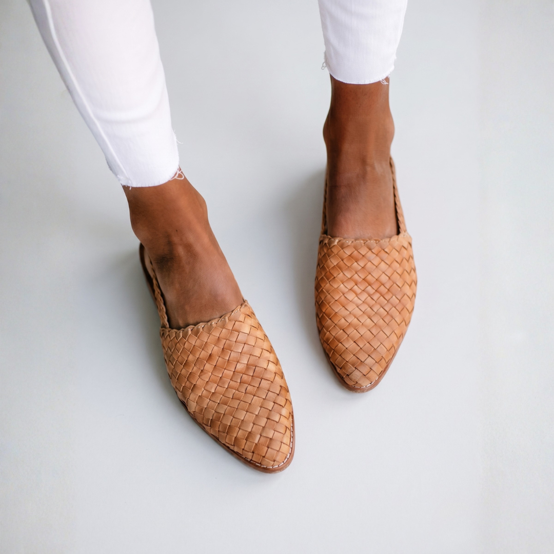 Tan woven orthopedic sandals displaying consistent basket-weave pattern and support sole