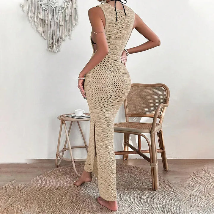 Rear view of beige sleeveless crochet maxi dress featuring black nape tie detail