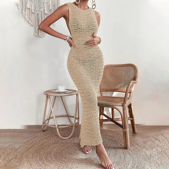 Beige open-knit crochet maxi dress showing flared hem and form-fitting drape