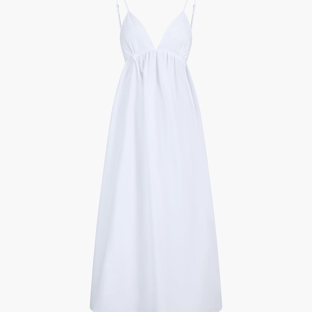 White cotton A-line maxi dress on mannequin with deep V-neck and spaghetti straps