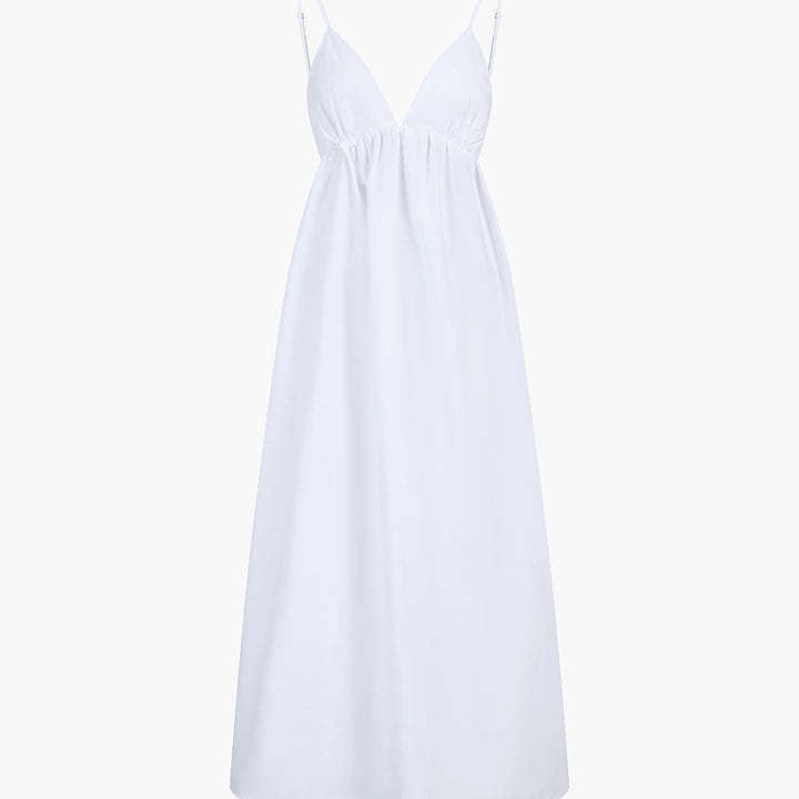 White cotton A-line maxi dress on mannequin with deep V-neck and spaghetti straps