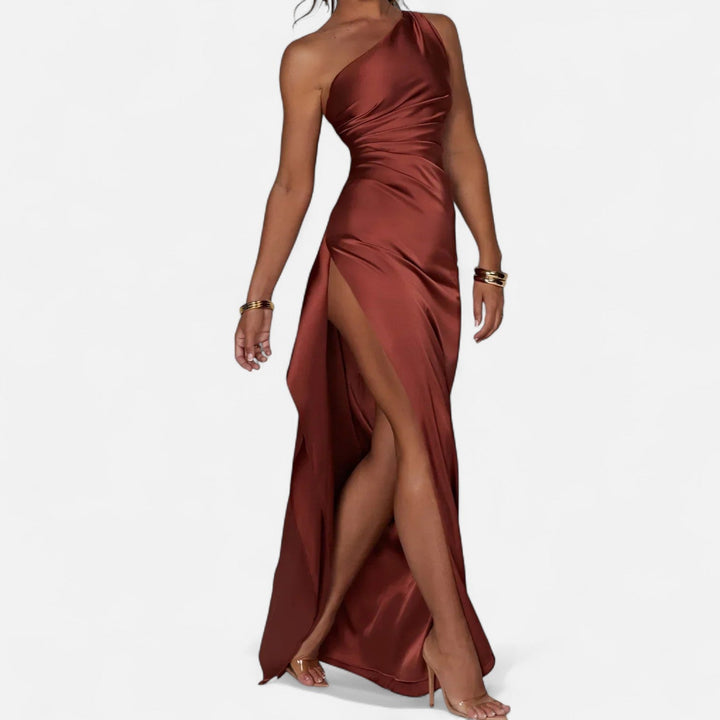 Burgundy one-shoulder satin gown with ruched bodice and flowing column skirt