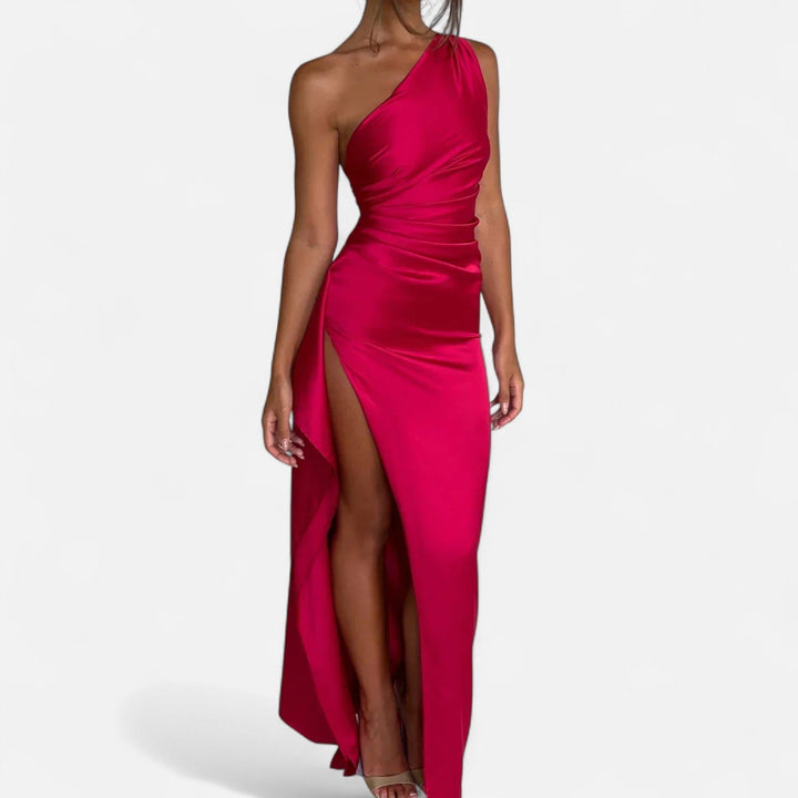 Vibrant fuchsia one-shoulder maxi dress with lustrous satin finish and high slit