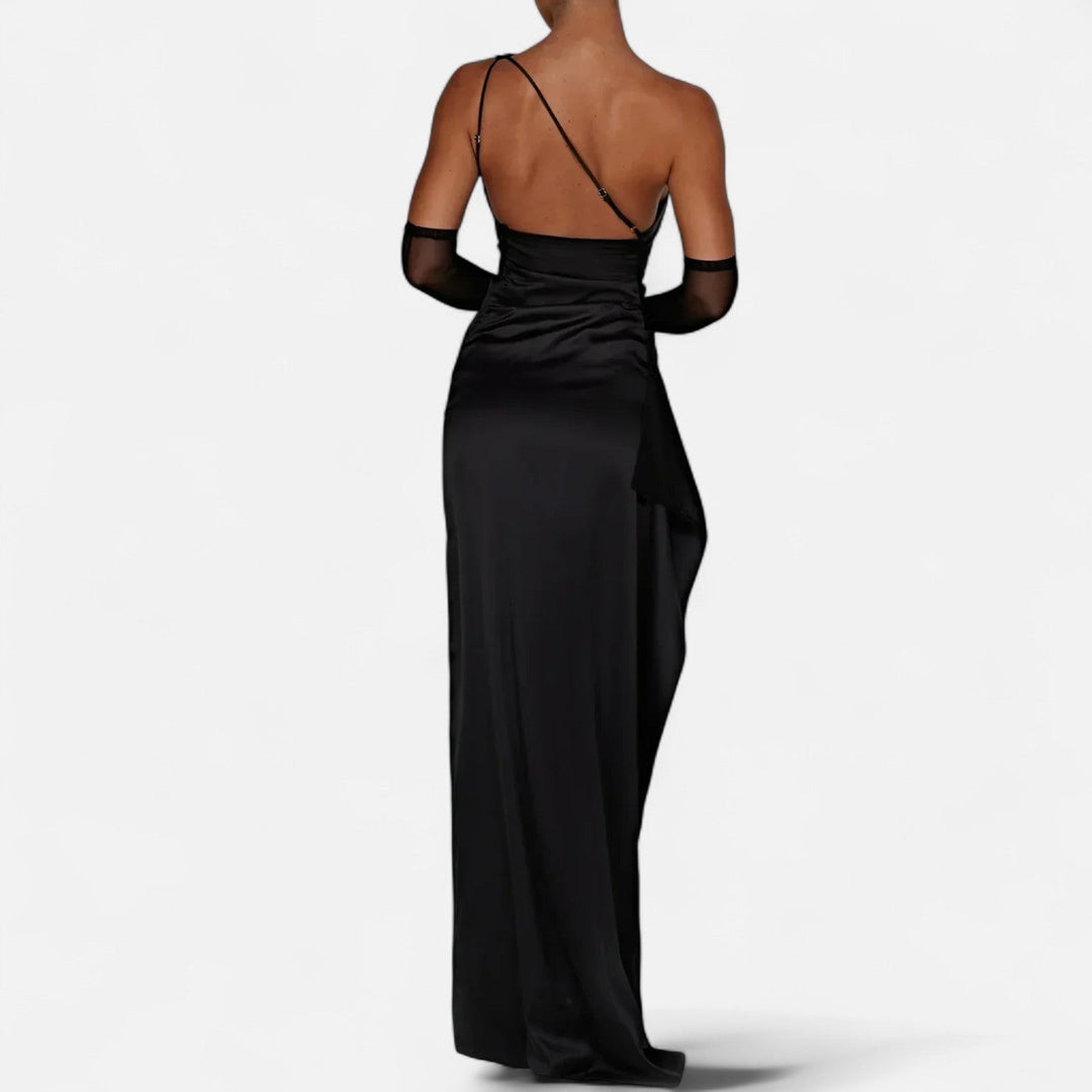 Black one-shoulder evening gown showing low open back and draped side panel