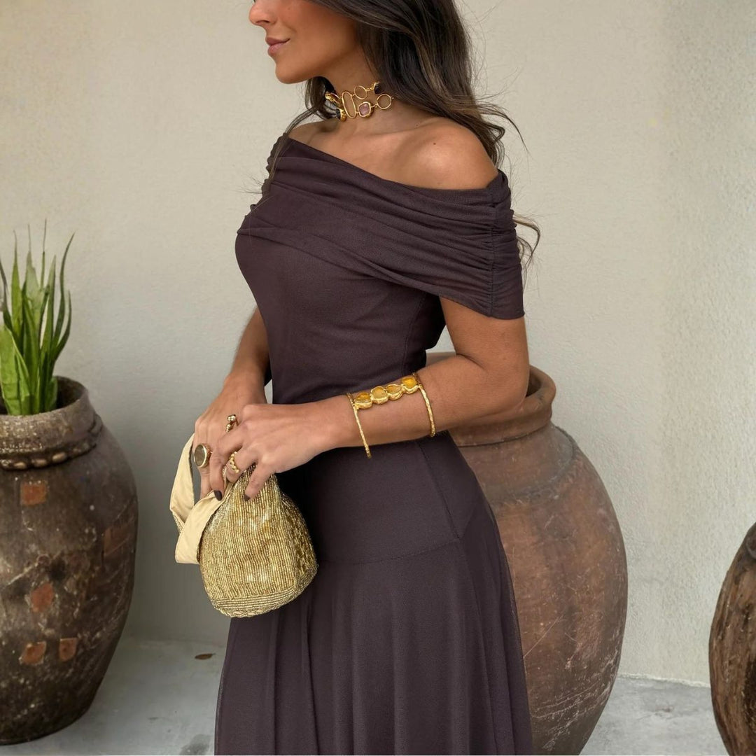 Side view of dark brown draped off-shoulder maxi dress showing gathered bust detail