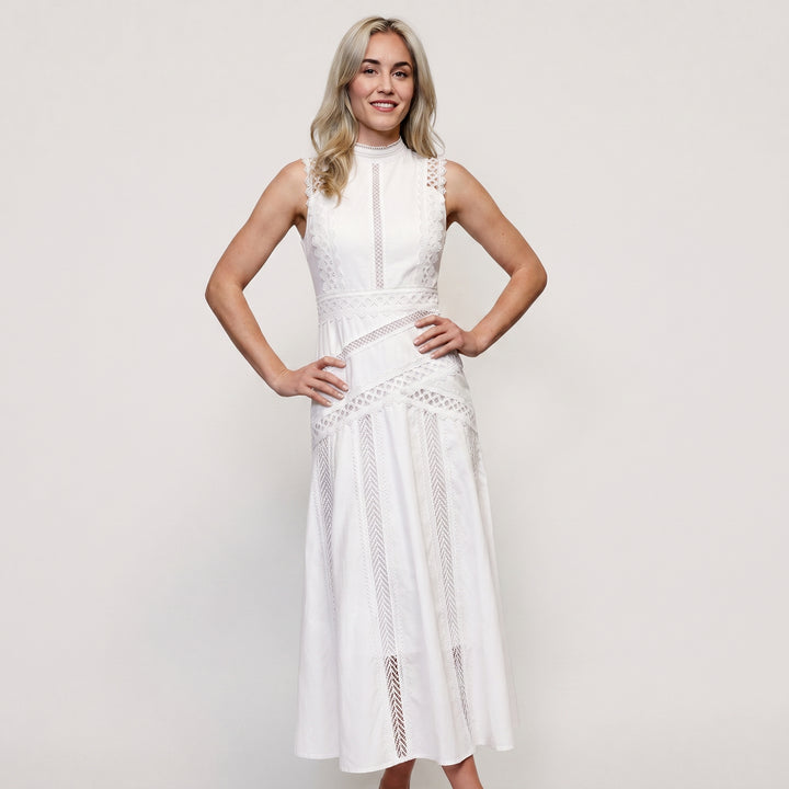 White sleeveless wedding guest midi dress with geometric cutwork lace patterns