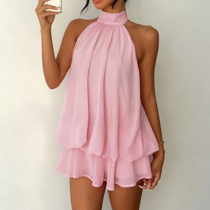 Soft pink halter neck mini dress full body shot highlighting flowing chiffon drape