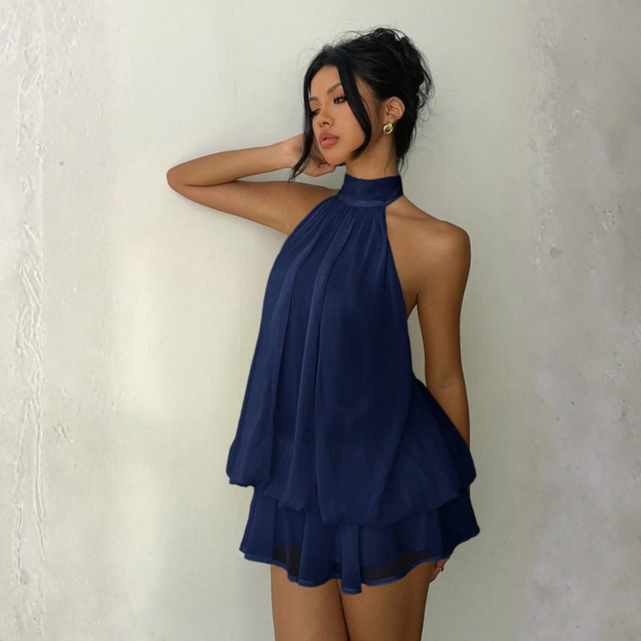 Navy blue halter neck mini dress with open back and tiered ruffled chiffon hem
