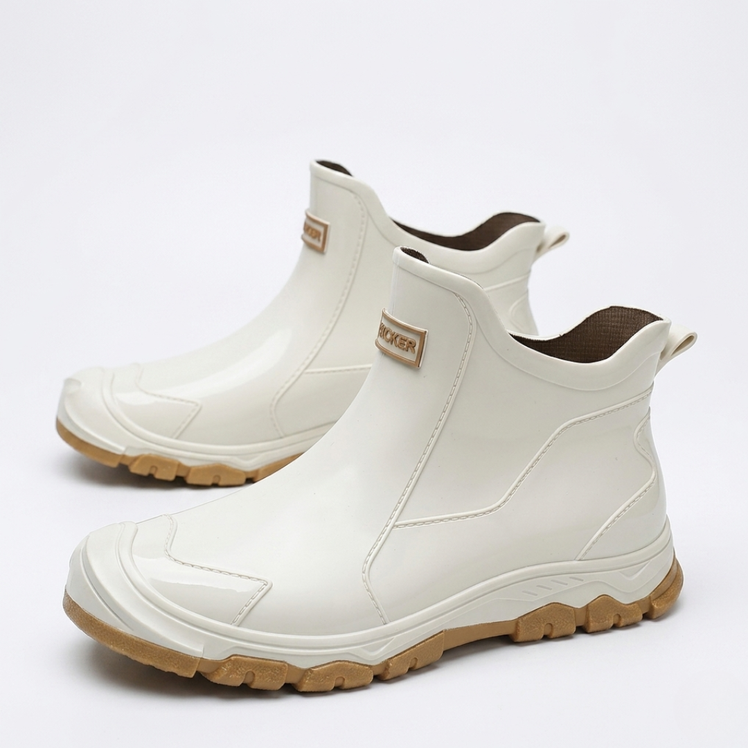 White slip-on terrain boots with tan outsole and reinforced toe detail