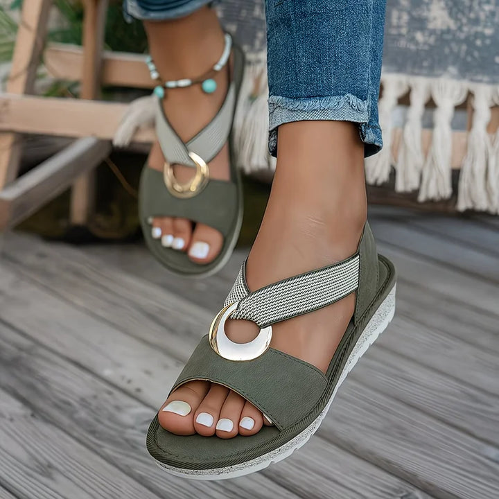 Olive green women's arch support sandals with crisscross strap and gold ring accent
