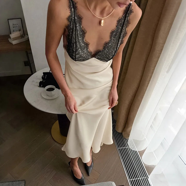 Champagne satin slip dress with black lace V-neck and draped front detail