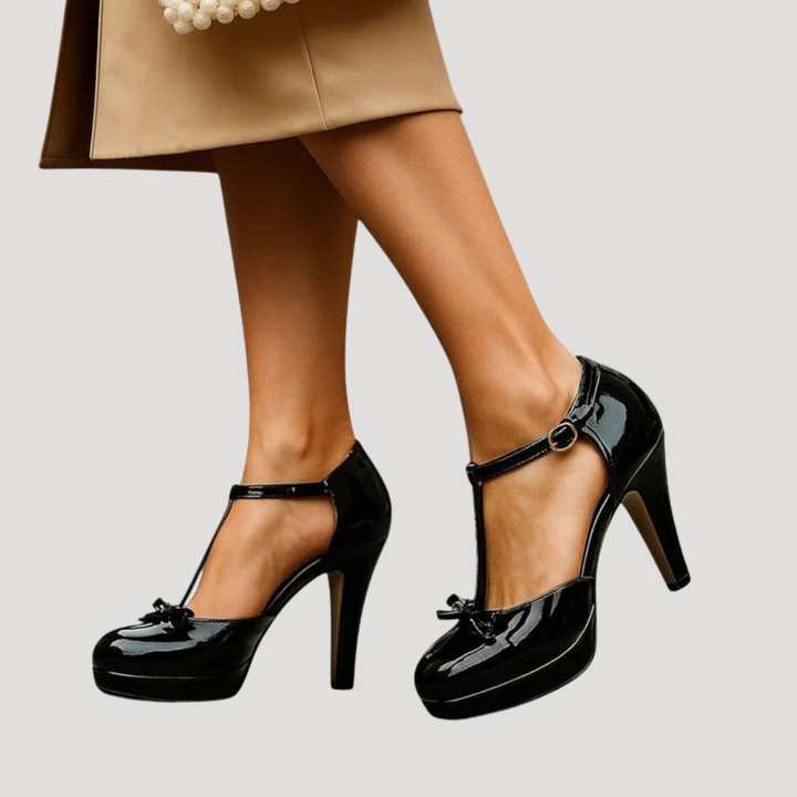 Black patent leather Mary Jane platform pumps with bow detail and thick heel