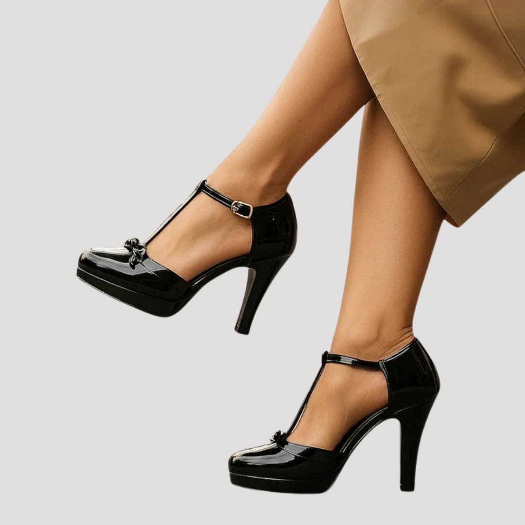Glossy black patent leather Mary Jane platform pumps with stiletto heel and seated pose