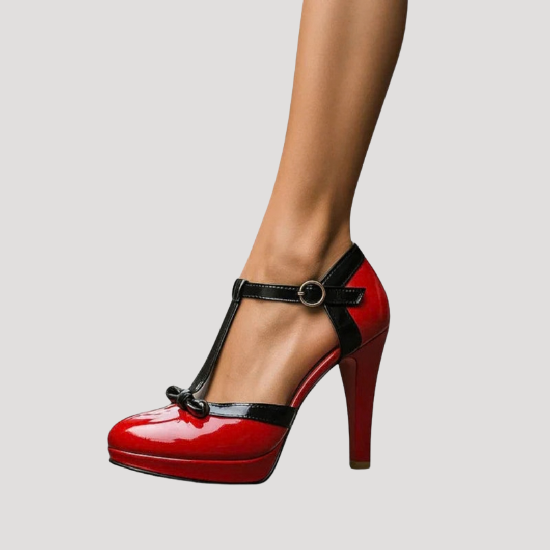 Red patent leather Mary Jane platform pumps with black ankle strap and gold buckle