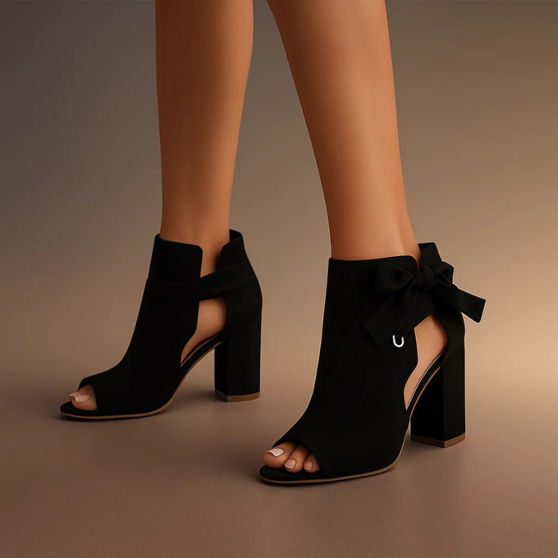 Matte black peep-toe ankle boots featuring silver ring bow accent