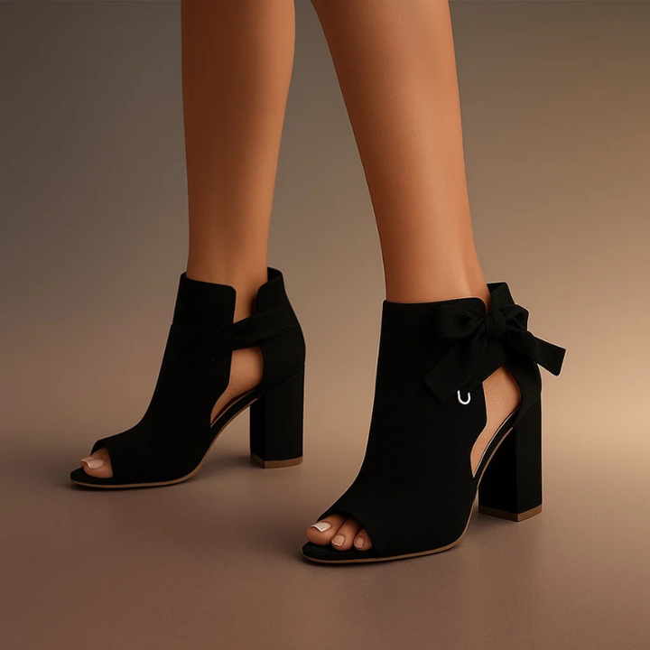Matte black peep-toe ankle boots featuring silver ring bow accent