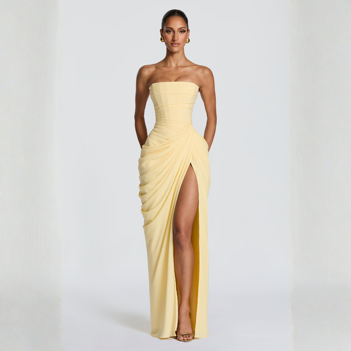 pale yellow strapless maxi dress dynamic pose highlighting high thigh slit
