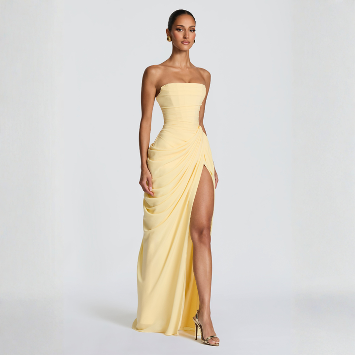 pale yellow strapless corset maxi dress three-quarter pose with side slit