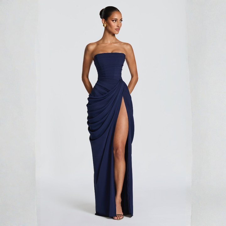 navy blue side profile strapless maxi dress showing draped skirt silhouette