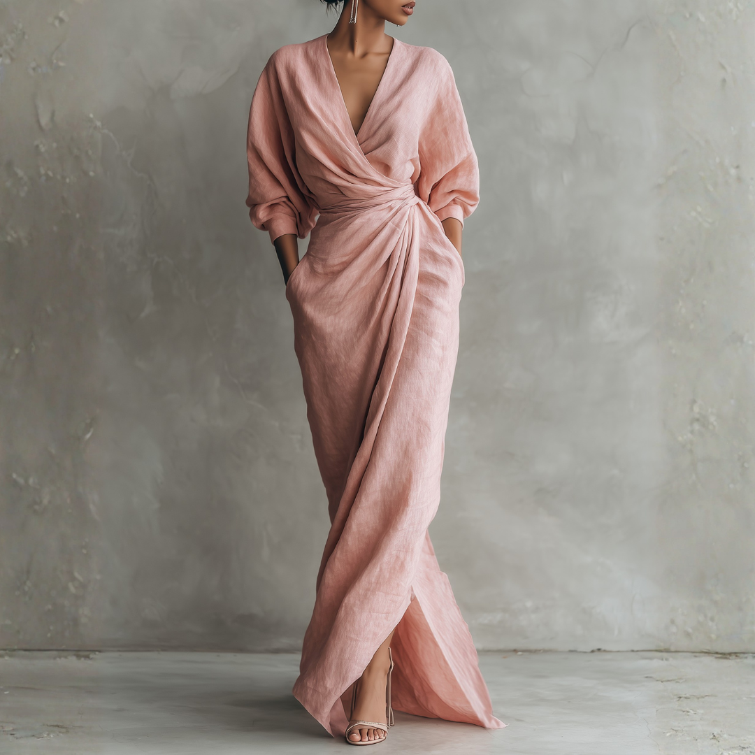 Blush pink linen wrap maxi dress front view with deep V-neck, twisted waist detail, and side pockets