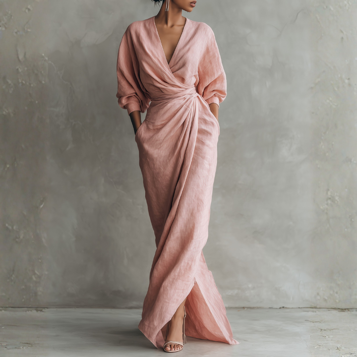 Blush pink linen wrap maxi dress front view with deep V-neck, twisted waist detail, and side pockets
