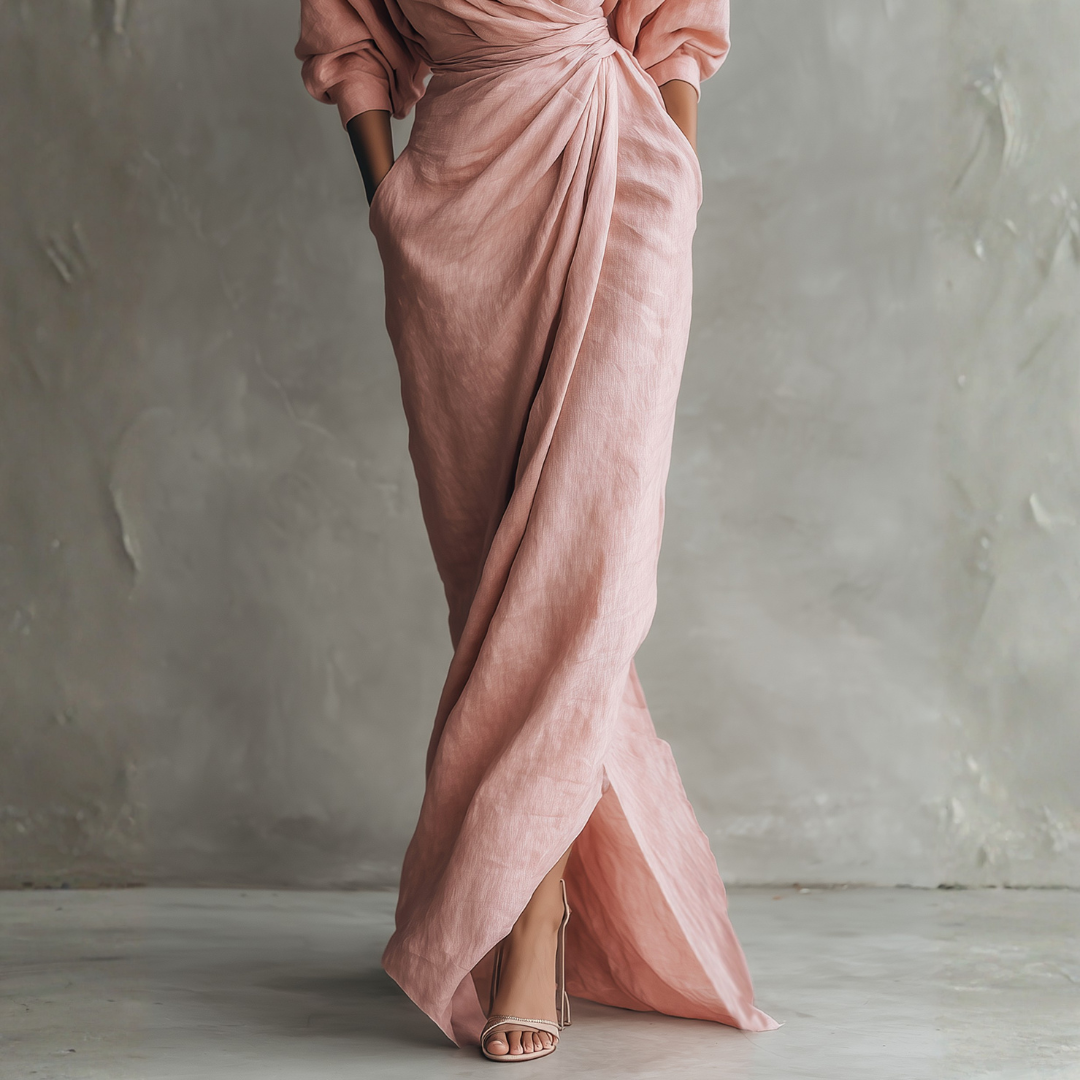 Close-up of blush pink linen wrap maxi dress showing high slit texture and side pocket detail
