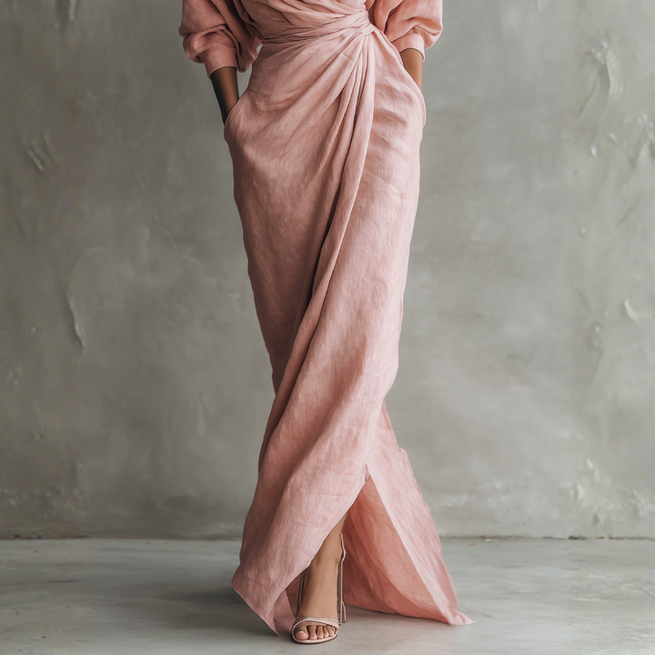 Close-up of blush pink linen wrap maxi dress showing high slit texture and side pocket detail