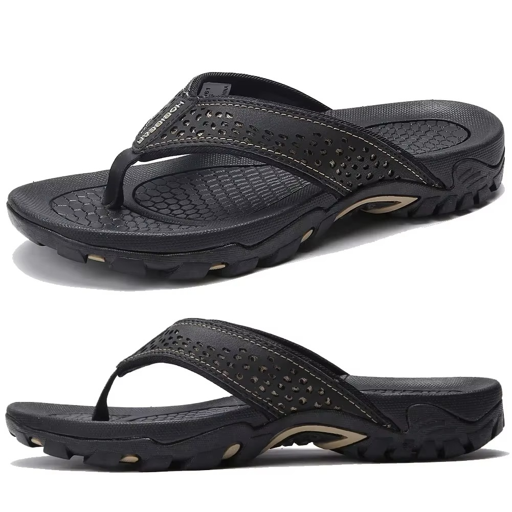 Pair of black MOBIEAR flip flops with hexagonal footbed texture and deep treads