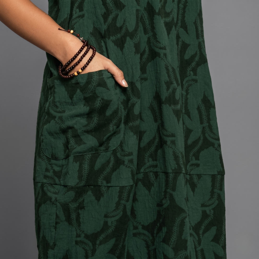 Dark green textured jacquard midi dress close-up showing pocket detail