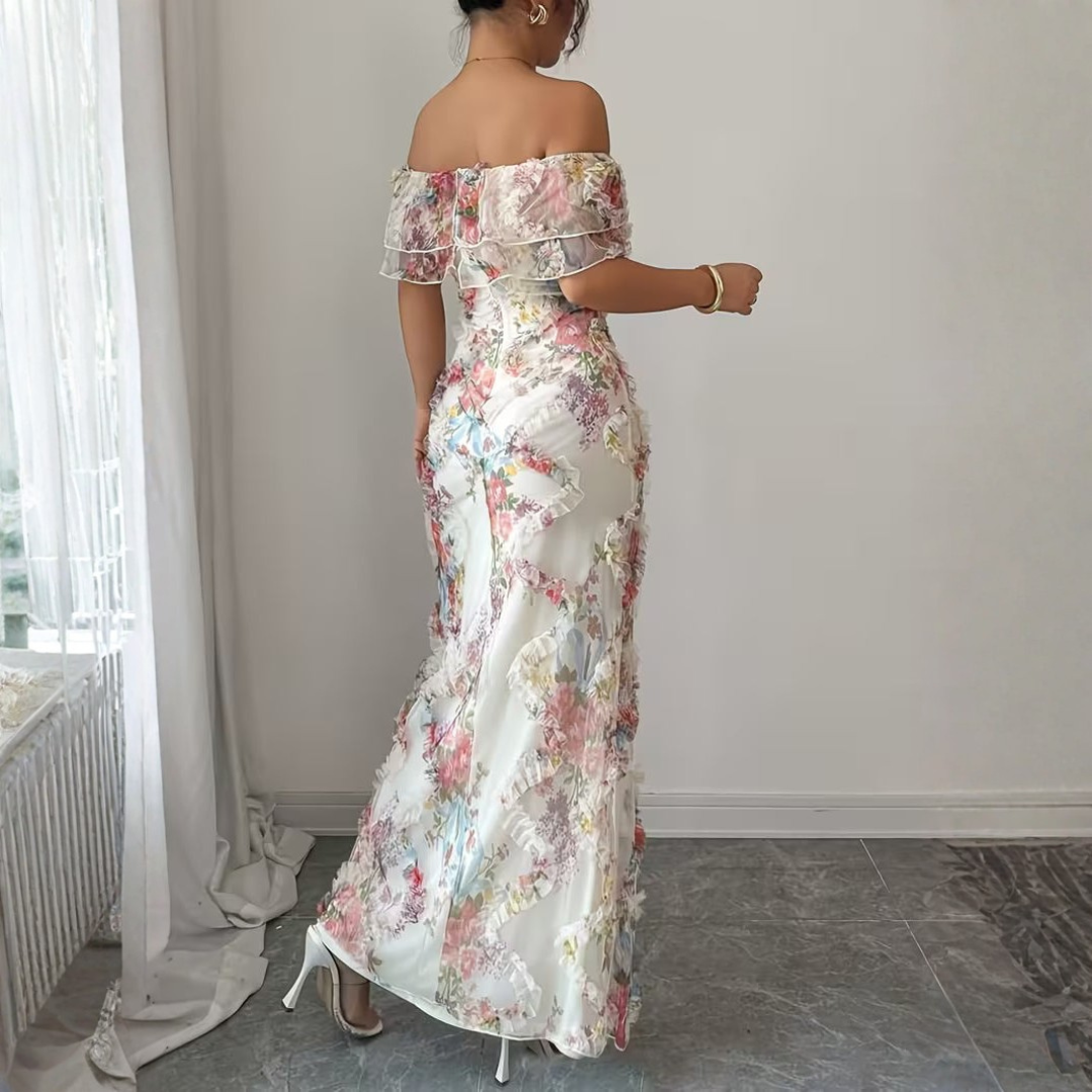 Rear view of white floral maxi dress featuring vertical ruffle flounce sides