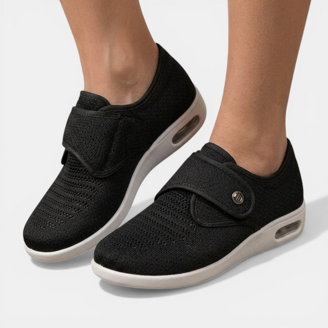 Black orthopedic walking sneakers with wide velcro strap and transparent air cushion heel