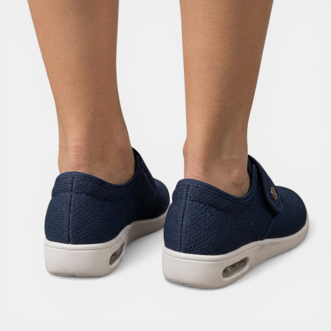 Navy blue orthopedic walking shoe rear view highlighting ribbed knit upper and heel cushion