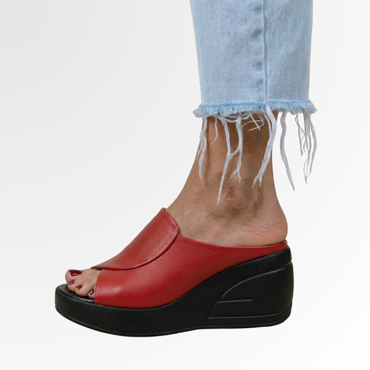 Red peep toe platform wedge sandal featuring black sole and faux leather instep strap