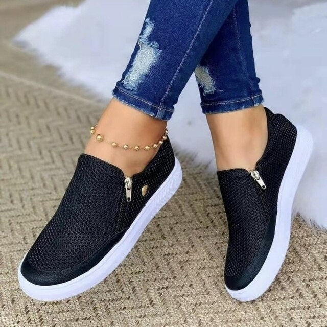 Black platform slip-on sneakers with mesh upper and side zipper