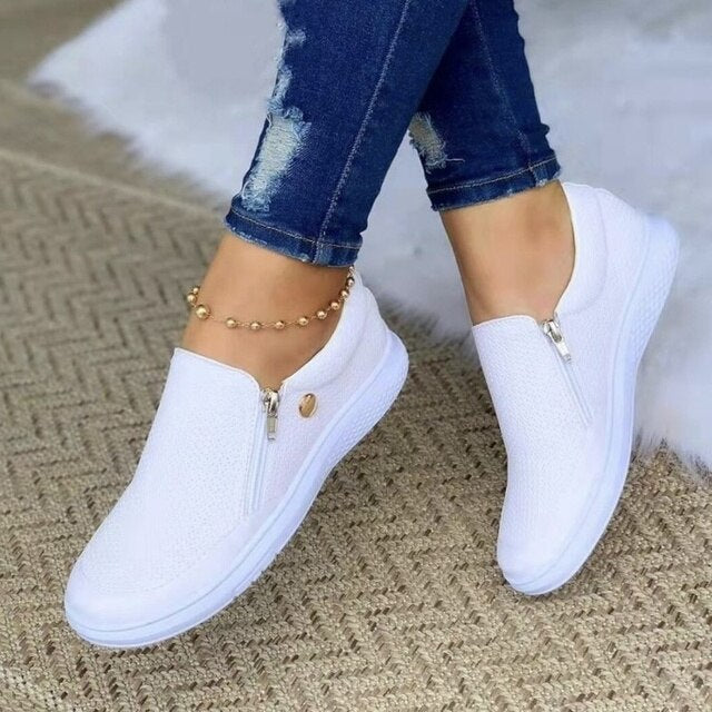 White platform slip-on sneakers with mesh upper and side zipper